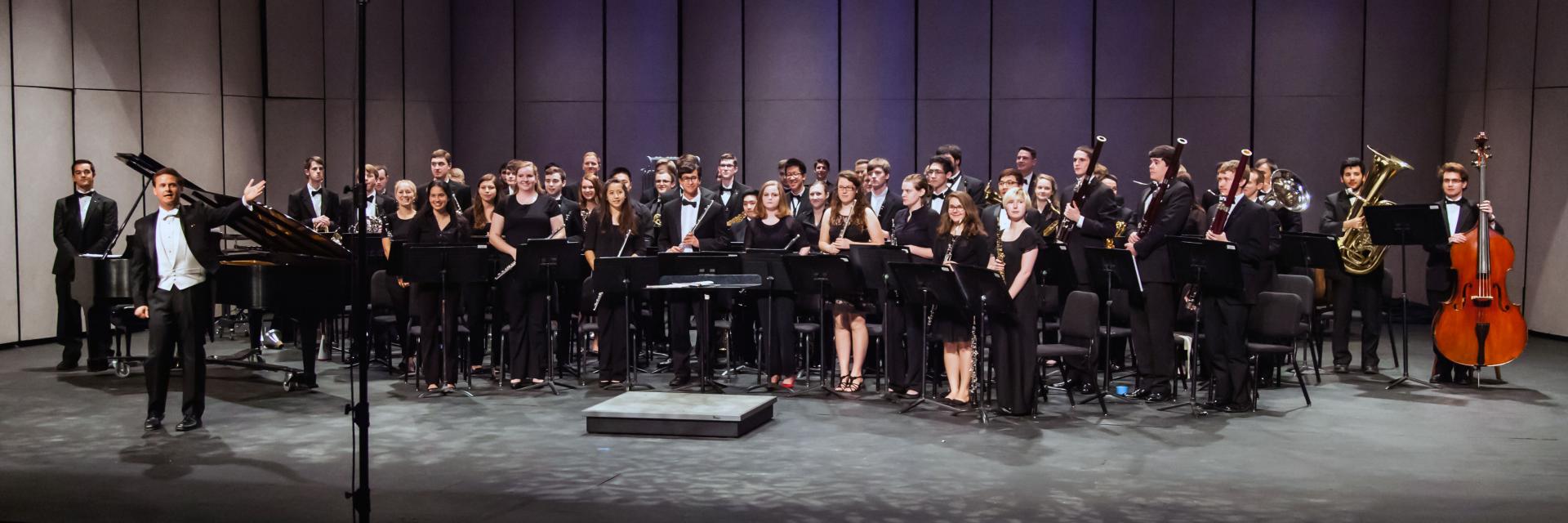 The Symphonic Band pauses for a bow at the end of a concert.